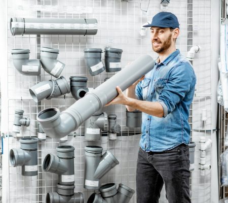 Man choosing pipes in the plumbing shop