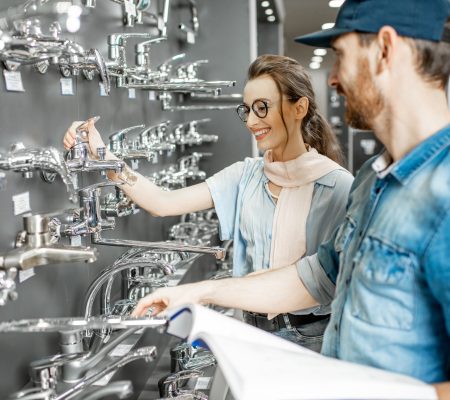 Woman with salesman in the plumbing shop